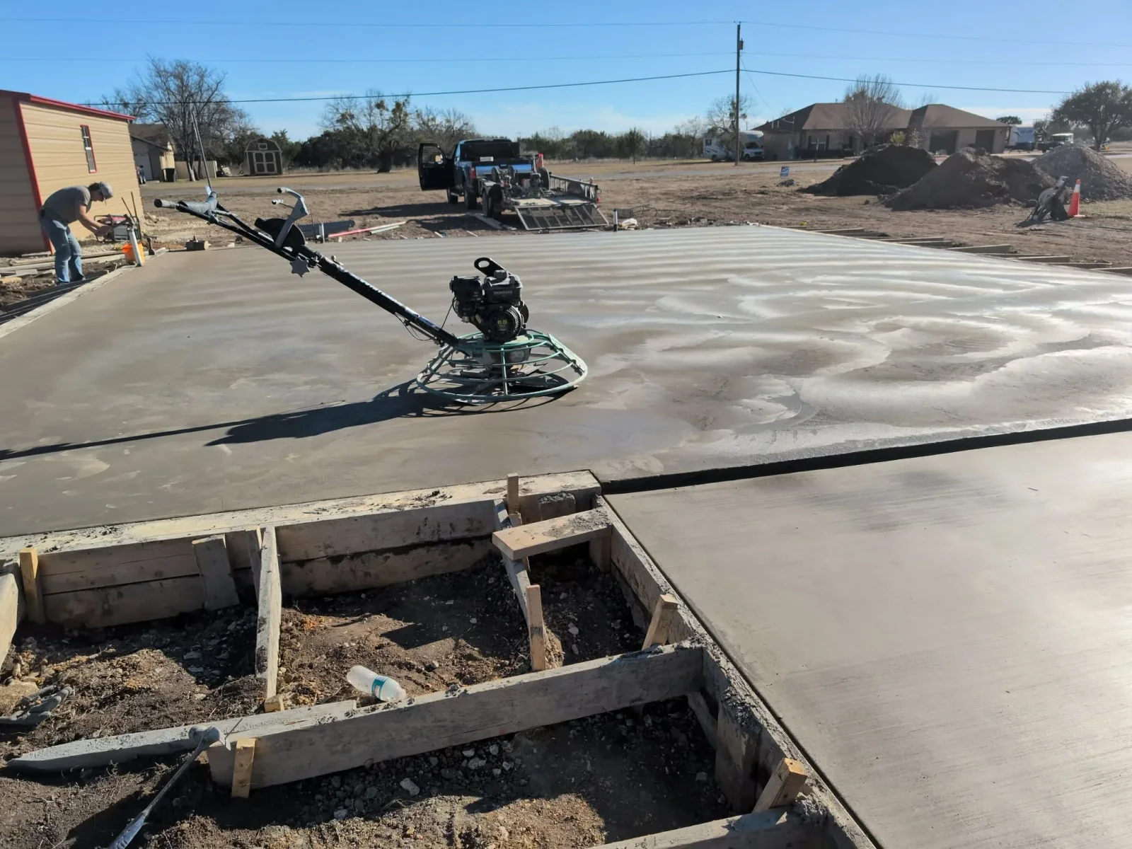Concrete slab finishing with power trowel on large residential foundation pad
