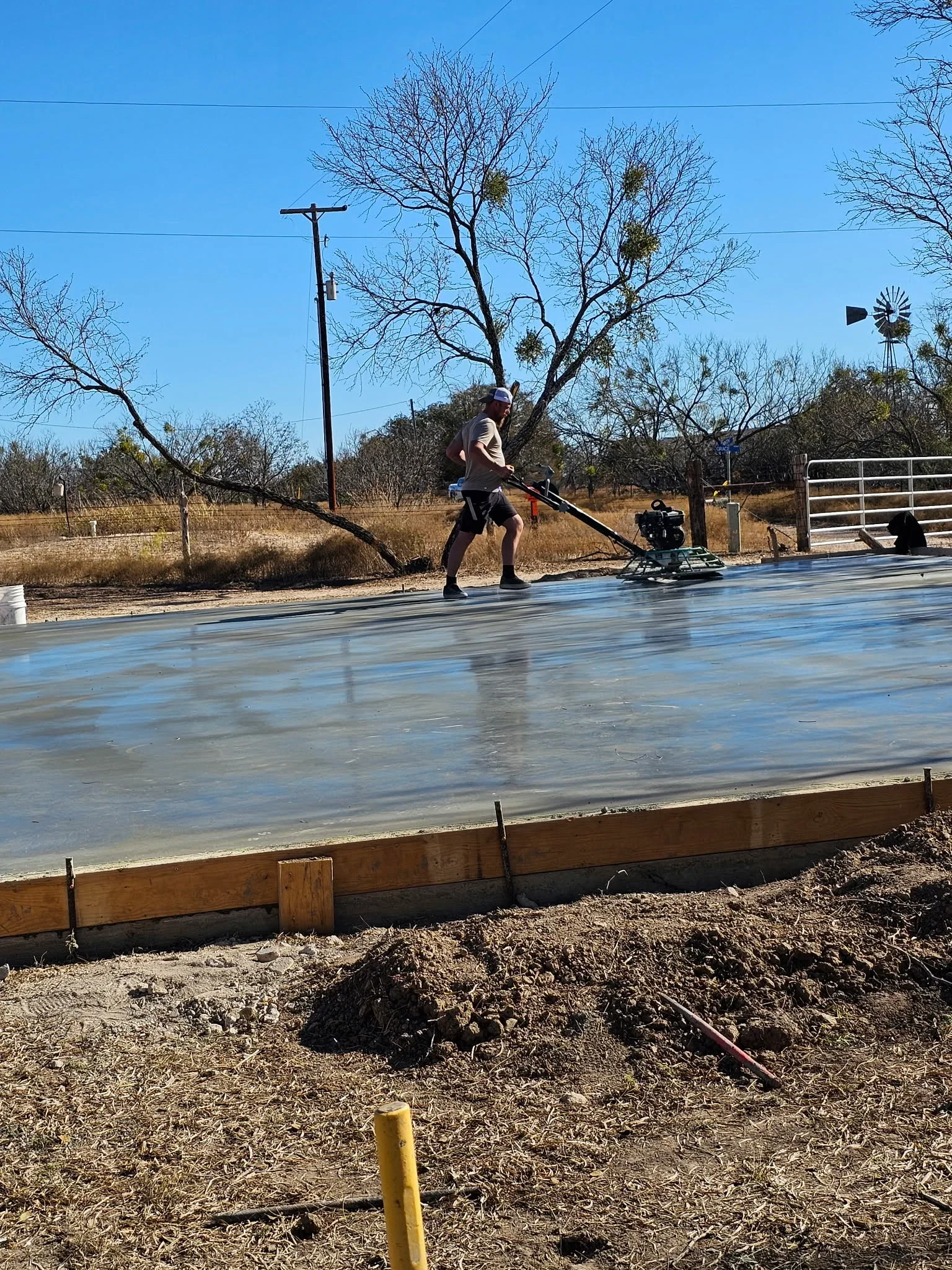 Smooth concrete skating rink with wooden frame border and finished surface ready for use